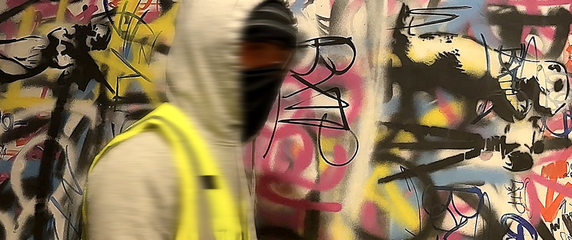 Justin Ferland in front of a graffiti wall